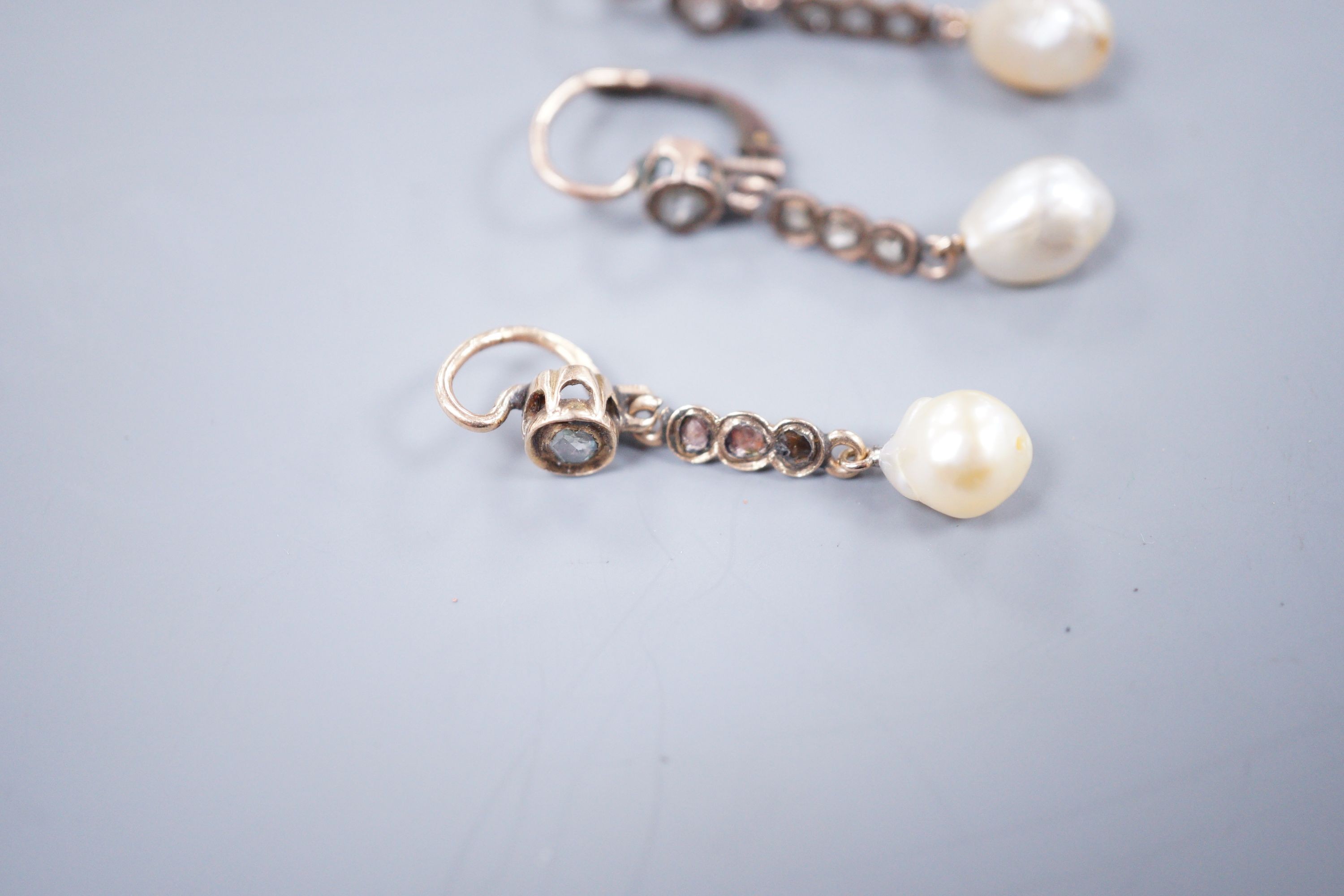 A pair of yellow metal, baroque pearl and rose cut diamond set drop earrings, 38mm and a similar pendant, gross weight 5.9 grams.